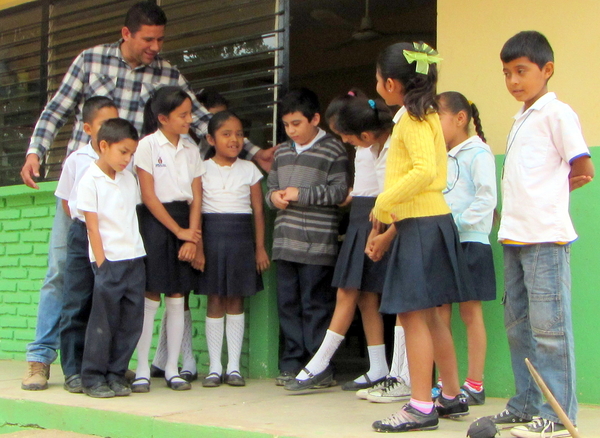 Teacher, Mario Alfonzo, encourages Tonio to take part in activities with the other children